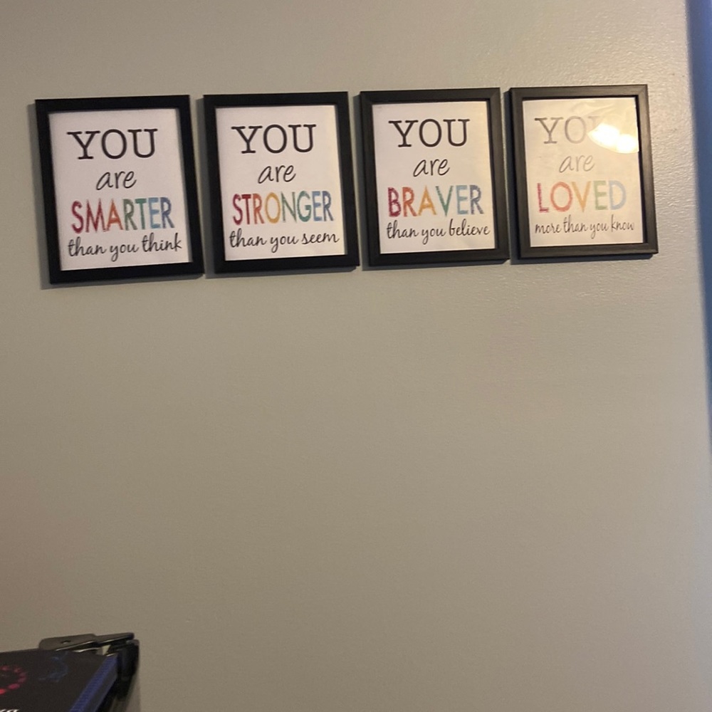 4 pictures with frames of positive quotes.